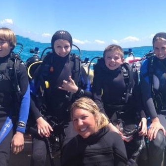 a group of people on a boat posing for the camera