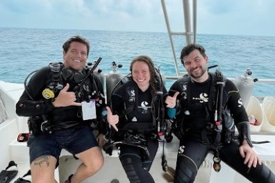 a group of people standing next to a body of water