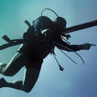 a person flying through the air while swimming in a body of water